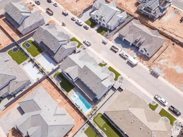 Aerial perspective showcasing residential properties with varied rooflines and front yard landscaping