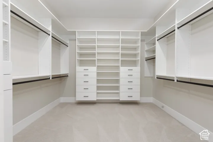 Built-in closet system with shelving, drawers, and hanging rods