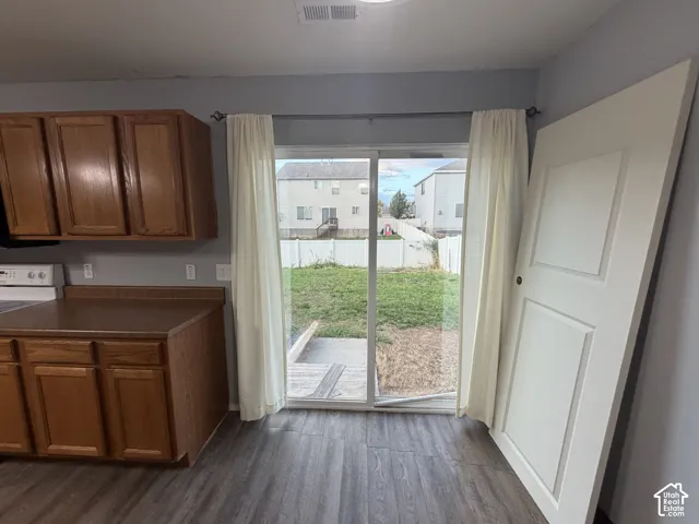 Wood-finish flooring throughout, with sliding glass door access to the outdoor area
