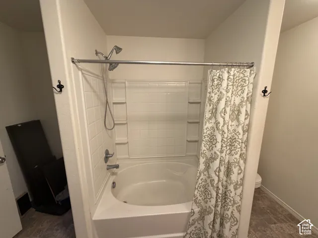 Tub and shower combination with white tile surround