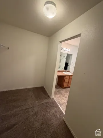 Wall-to-wall carpeting and overhead flush mount lighting