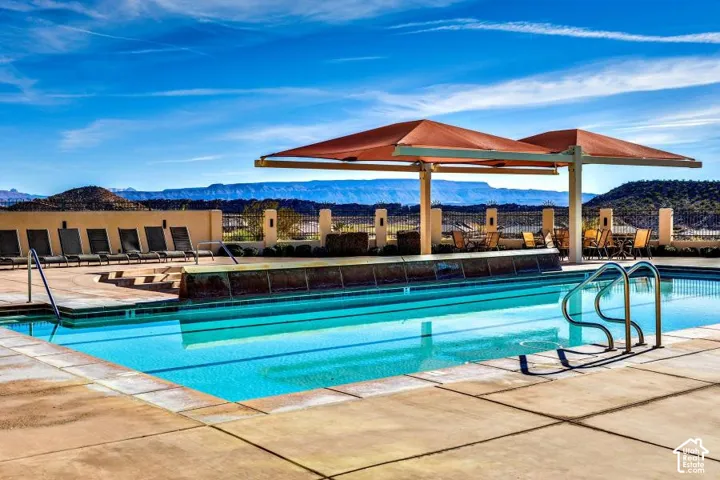 Outdoor swimming pool with integrated steps, surrounded by stone-finish paving