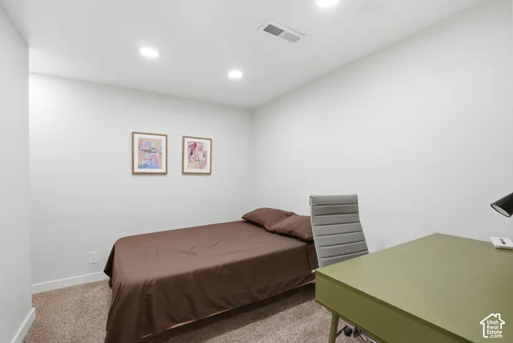 Recessed ceiling lighting, light neutral wall paint, and textured carpeting