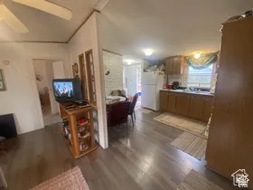 Wood-finish flooring throughout, ceiling fan, and recessed lighting
