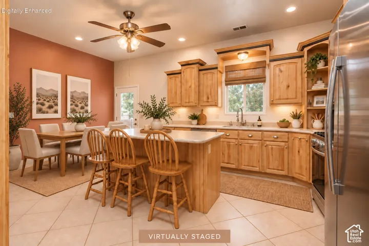 Kitchen featuring extensive natural wood cabinetry, stainless steel appliances, a center island with countertop, tile flooring, and recessed lighting