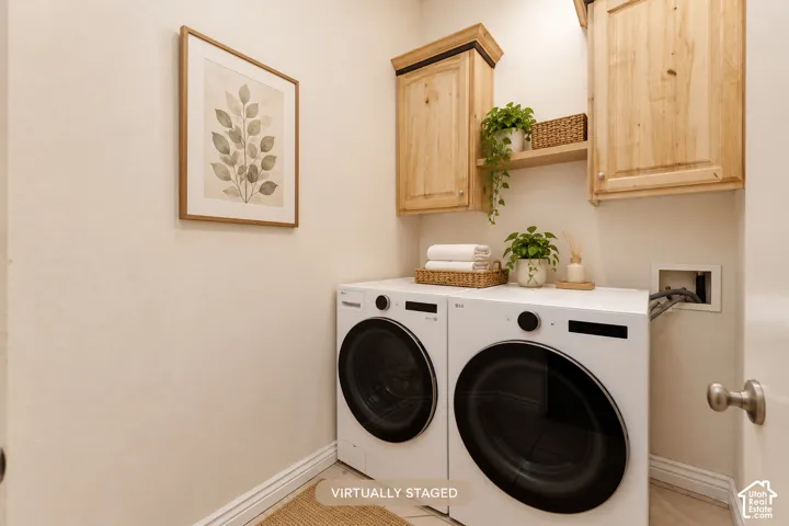 Laundry area featuring wood-finish cabinetry, an integrated wood-finish shelf, and light-toned walls