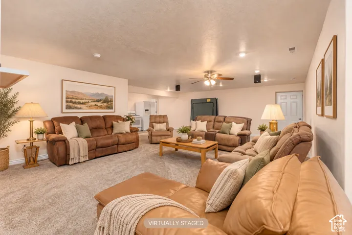 Spacious carpeted room featuring recessed lighting, a ceiling fan, and painted walls