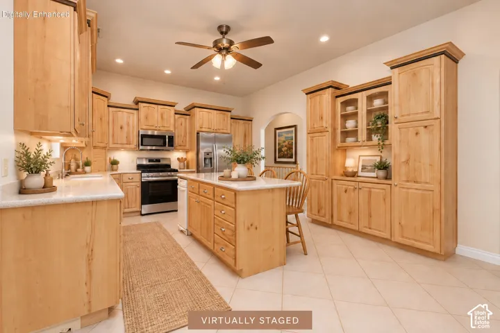 Kitchen featuring extensive natural wood cabinetry, stainless steel appliances, a center island with countertop, tile flooring, and recessed lighting
