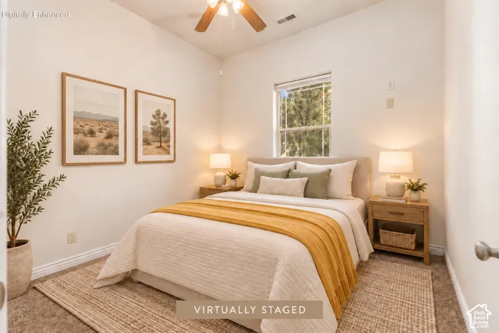 Bedroom 3 with vaulted ceiling with a ceiling fan, window with exterior scenery, and light-toned walls