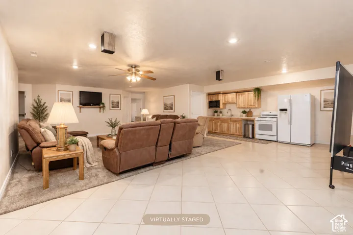 Kitchen/dining with recessed lighting, ceiling fan, and tile flooring complement the wood-finish cabinetry and white appliances