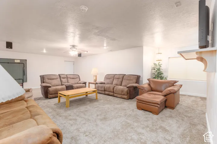 Spacious room featuring neutral carpeting, recessed lighting, and a ceiling fan