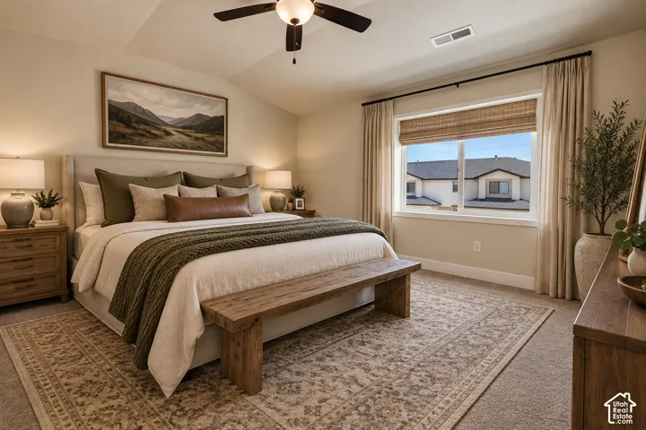 Carpeted flooring, vaulted ceiling, and a ceiling fan with integrated lighting