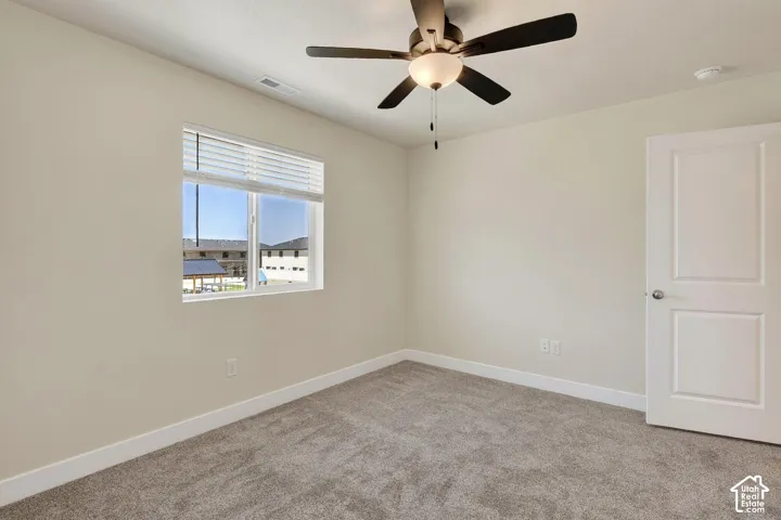Neutral-toned walls complement the gray carpeting