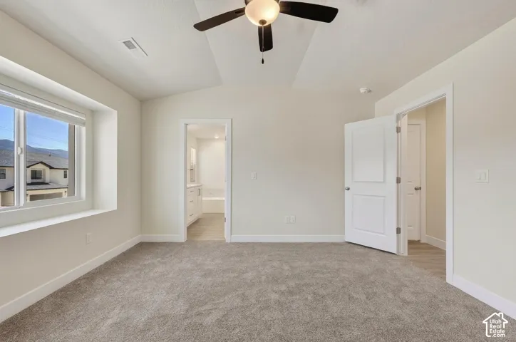Room featuring light-toned carpeting, a ceiling fan with integrated lighting, and a window with a deep sill