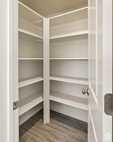 Built-in pantry shelving with durable wood-finish flooring