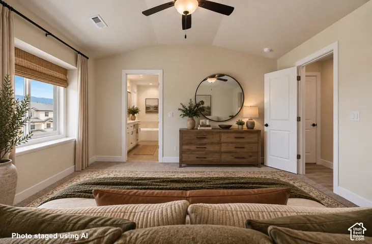 Vaulted ceiling with a ceiling fan, carpeted flooring, window with roman shades, and a two-panel interior door