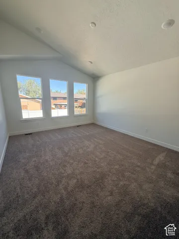 Vaulted ceilings with recessed lighting, triple windows, and wall-to-wall carpeting