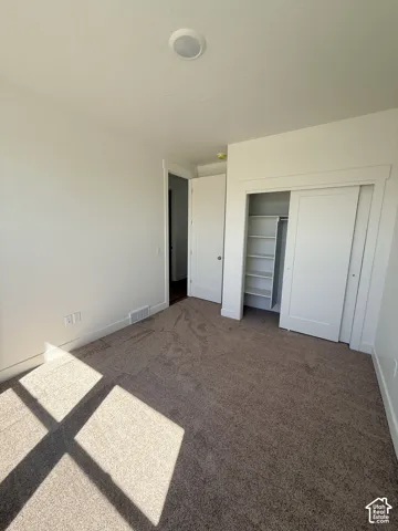 Neutral-toned carpet flooring and white walls