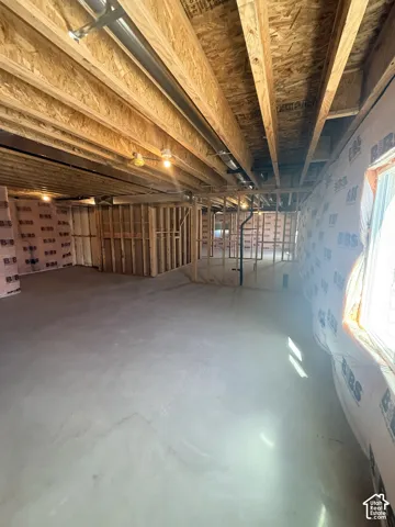 Framed interior with exposed ceiling joists, concrete flooring, and pre-insulated walls