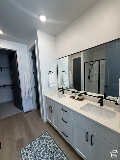 Dual vanity with white cabinetry, integrated sinks, black hardware, and light-toned countertops
