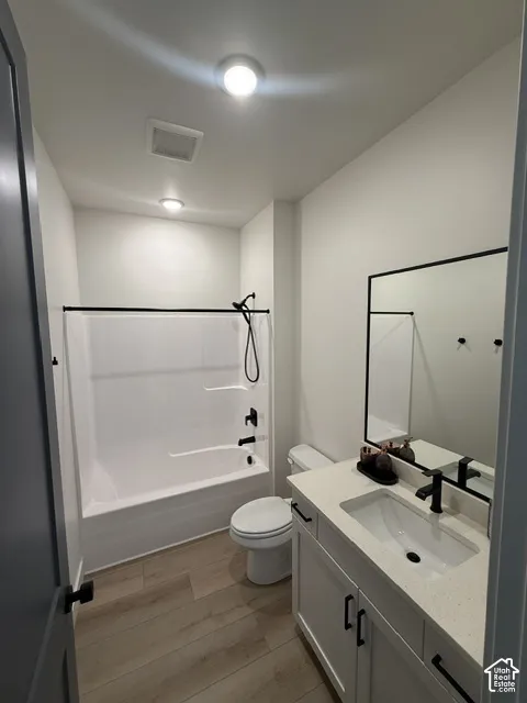 Bathroom featuring white vanity with stone-finish countertop, undermount sink, and matte black hardware