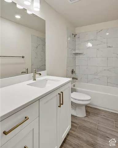 White vanity with bronze-finish hardware, integrated sink, and white countertop