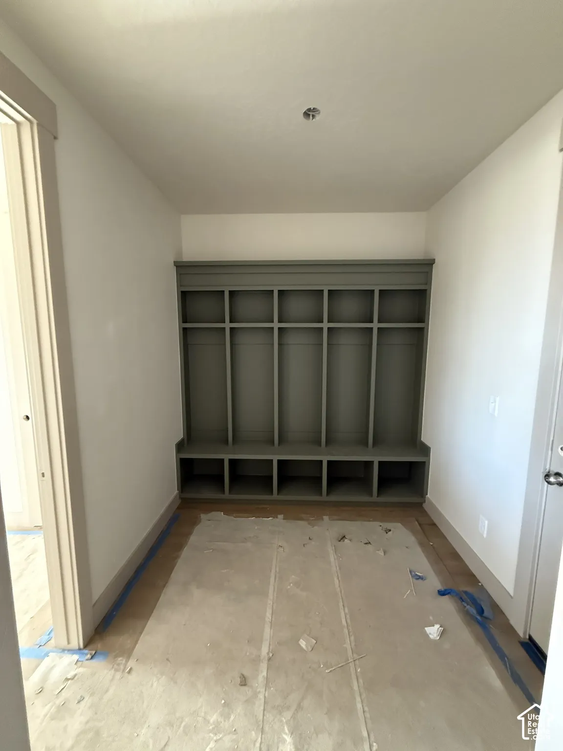 Built-in mudroom cabinetry featuring five upper storage cubbies and five lower open compartments with a neutral finish