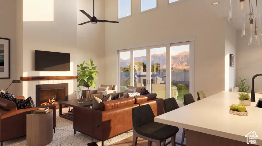Vaulted ceilings with clerestory windows, fireplace with tile surround and wood mantel, sliding glass door, and a kitchen island with seating