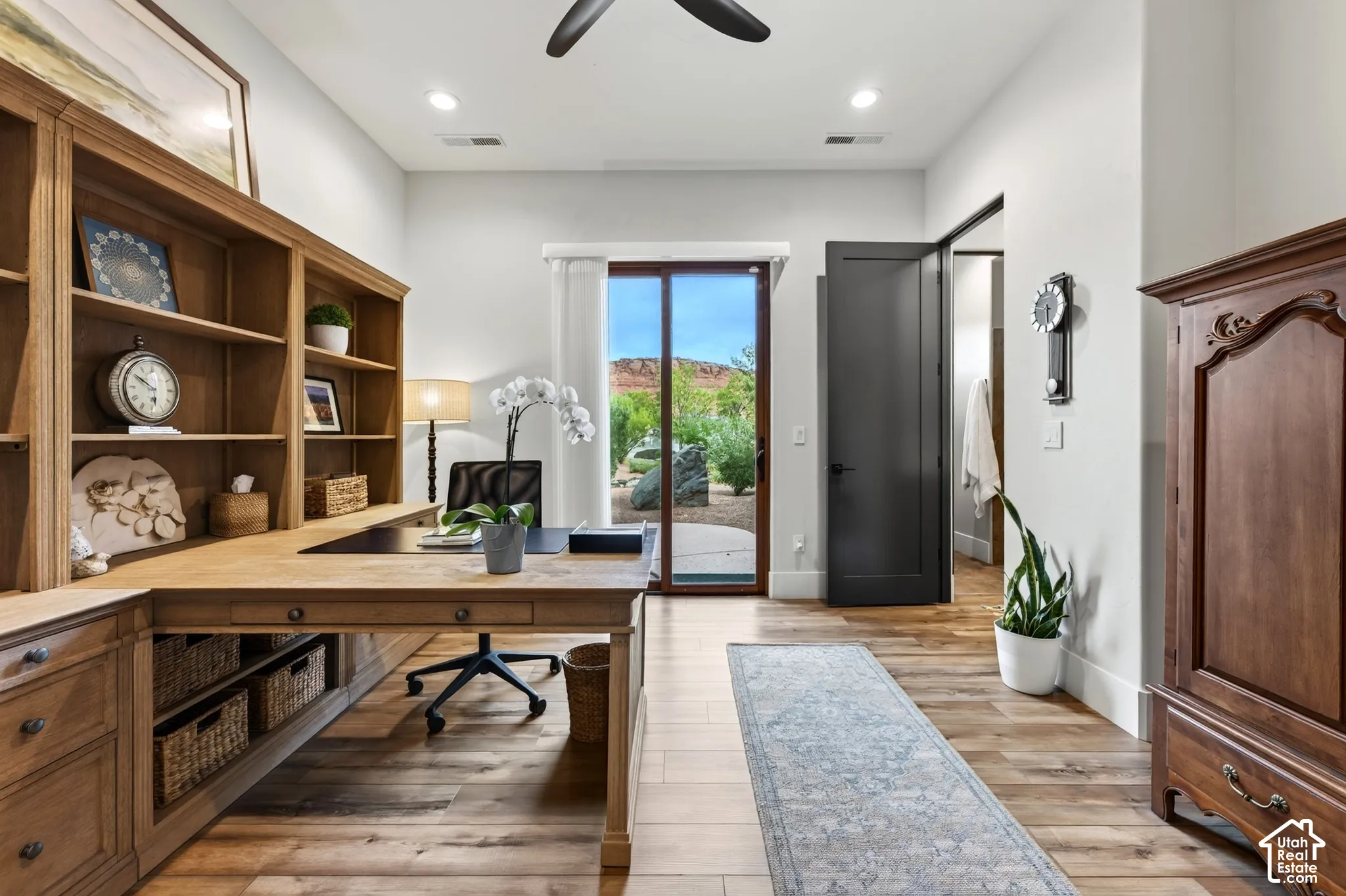 Den/Flex Room: Wood-finish flooring, built-in shelving, dark-finish interior doors, and a sliding glass door