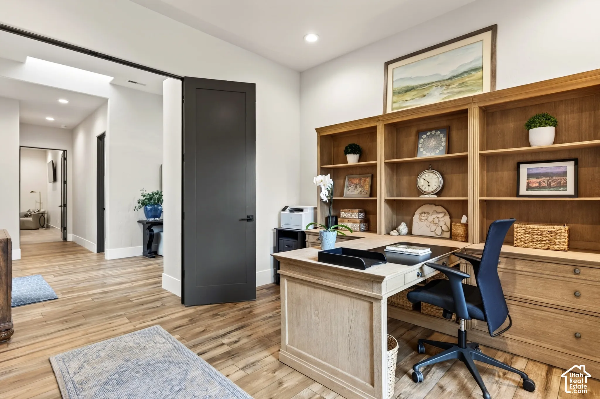Flex Room/ Bedroom: Wood-finish flooring throughout, with a skylight in the hallway