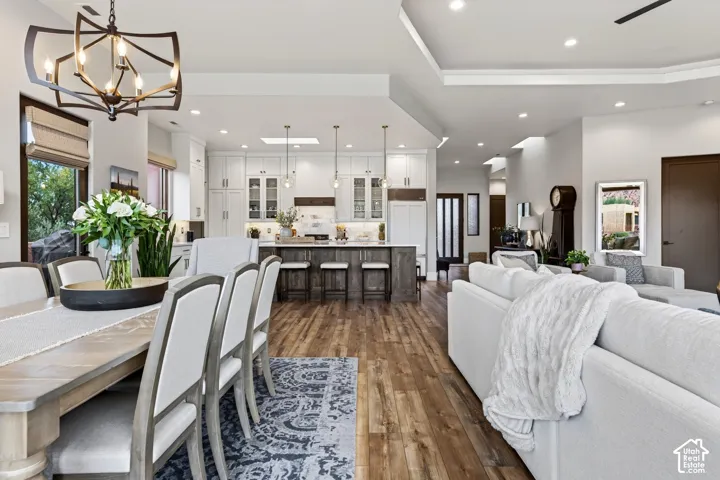 Open-concept living space featuring wood-finish flooring, recessed lighting, and a white coffered ceiling