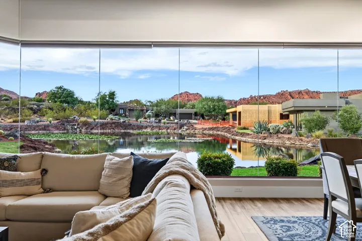 Expansive 28 FT wall of windows overlooking a tranquil water feature and natural desert landscape