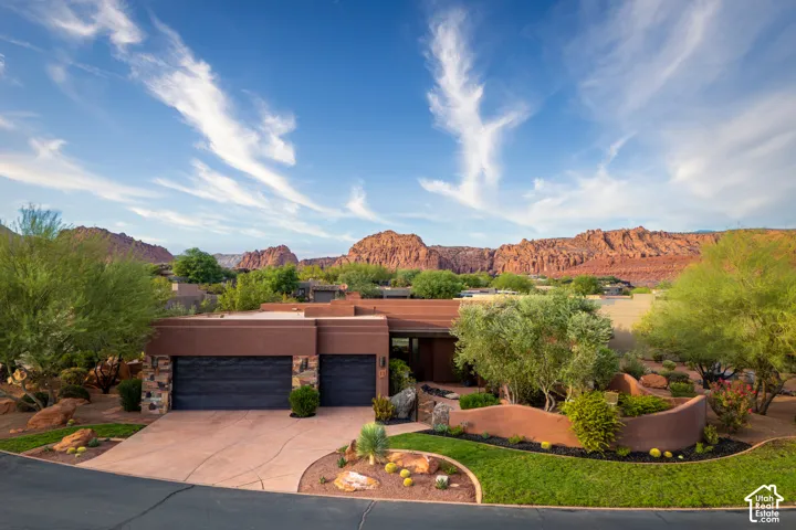 Contemporary architecture featuring a stucco exterior and stone accents