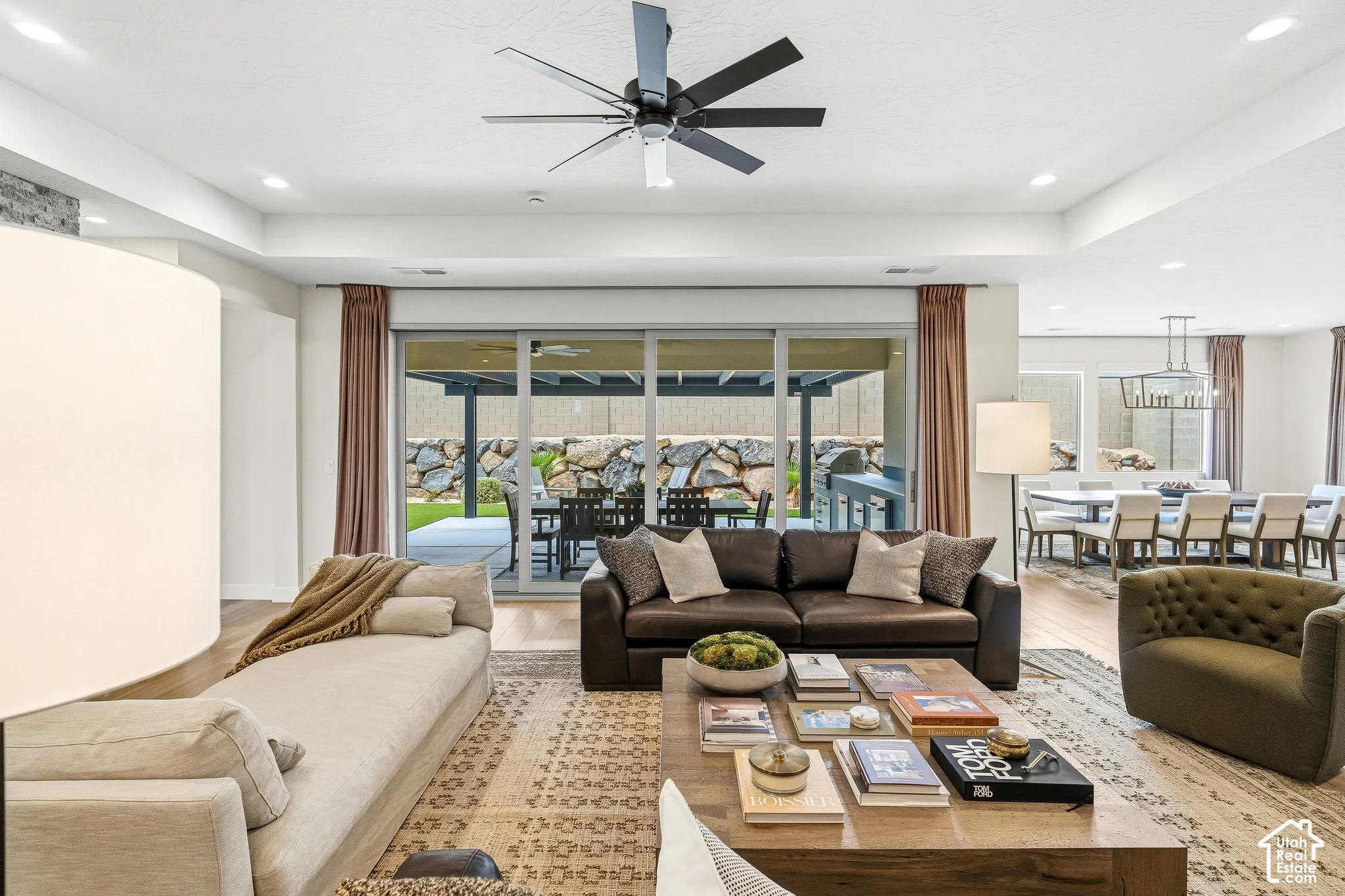 Recessed lighting, wood-finish flooring, and tray ceiling with a ceiling fan