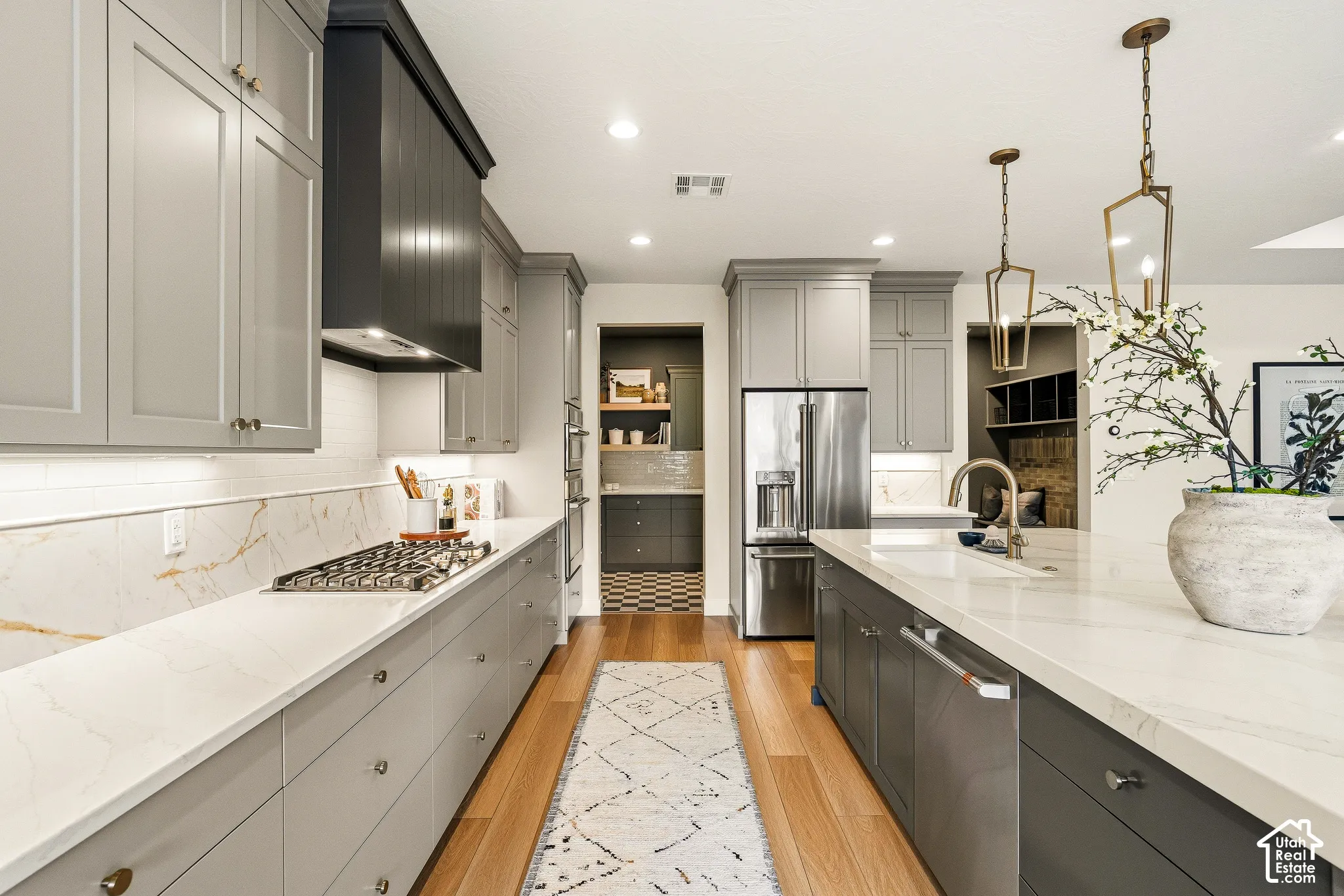 Kitchen featuring light wood-finish flooring, recessed lighting, and a stainless steel refrigerator