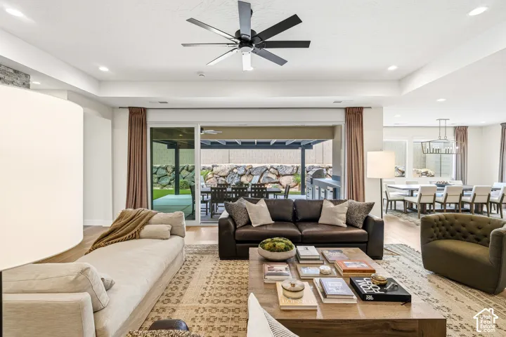 Recessed lighting and ceiling fan, wood-finish flooring, sliding glass door, and a covered patio area