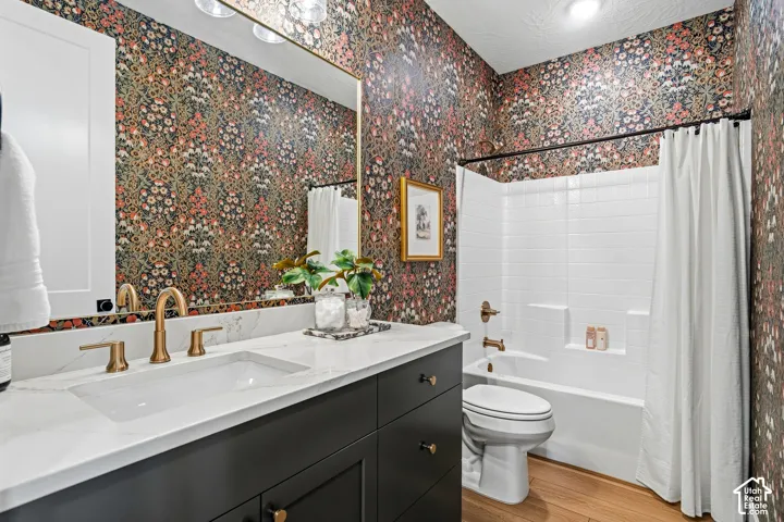 Dark wood-finish vanity with a white countertop and gold-finish fixtures