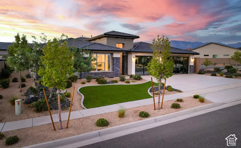 Contemporary exterior with stone accents and a paver driveway