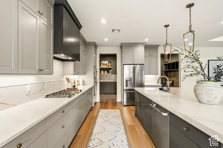 Kitchen featuring light wood-finish flooring, recessed lighting, and a stainless steel refrigerator
