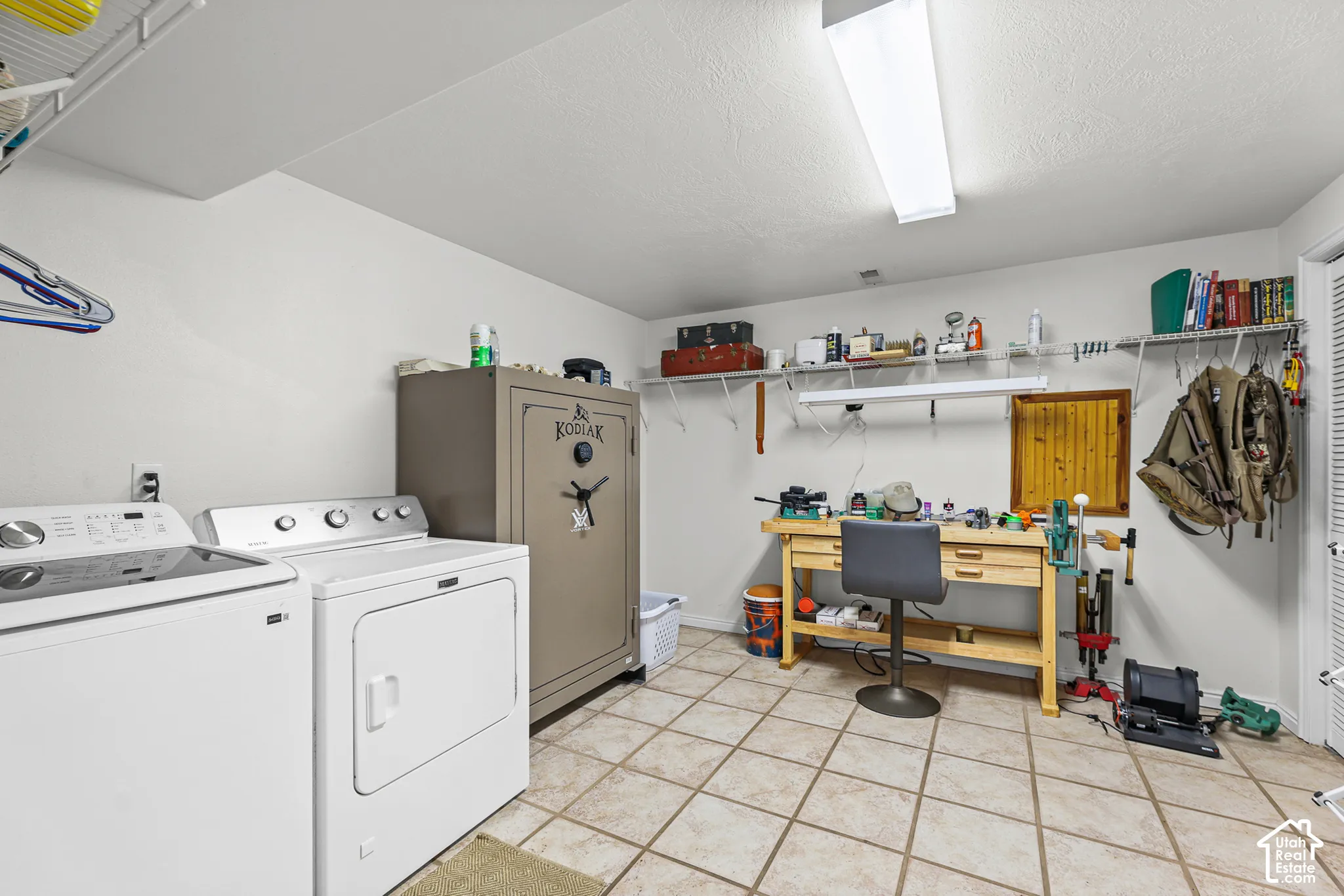 Tile flooring, built-in shelving, overhead lighting, and a white interior door