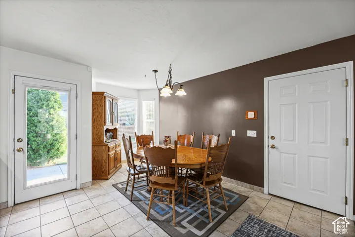 Tile flooring throughout with a glass-paned exterior door and a multi-paneled interior door