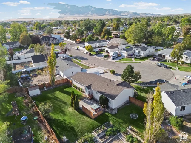 Expansive property featuring a well-maintained lawn, mature trees, and a wooden fence