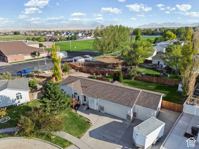 Single-story residence featuring a two-car garage, stone accents on the facade, and a paved driveway