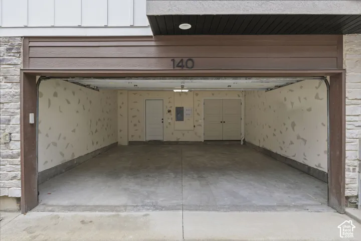 Attached garage with concrete flooring, recessed lighting, and dual interior doors