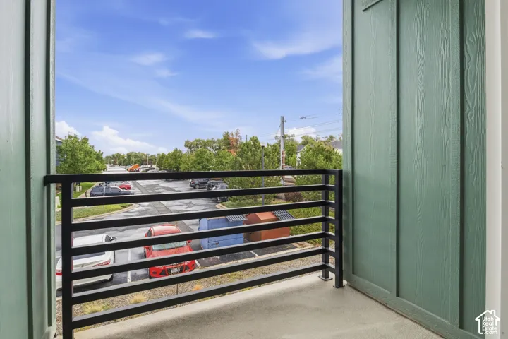 Private balcony with black metal railings and concrete flooring