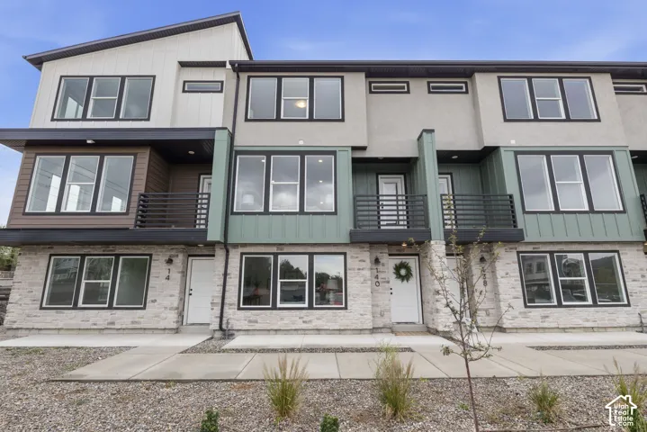 Modern exterior featuring stone veneer, stucco, and wood-look siding