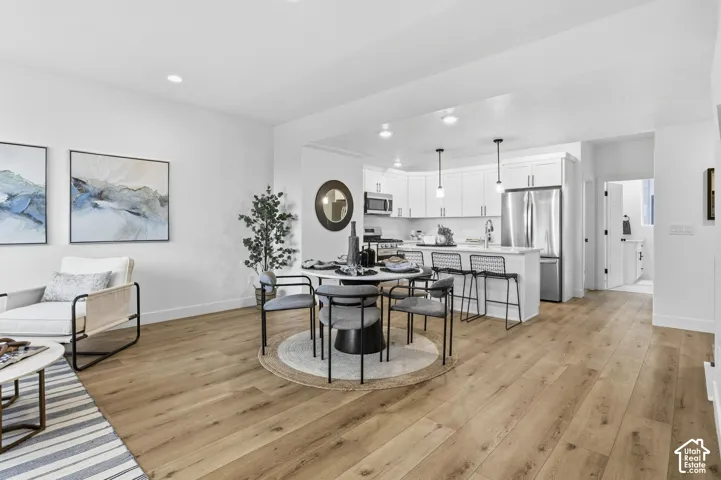 Open-concept living space with wide plank wood-finish flooring