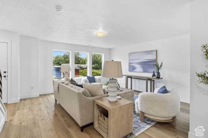 Light wood-finish flooring, crisp white walls, and multiple windows