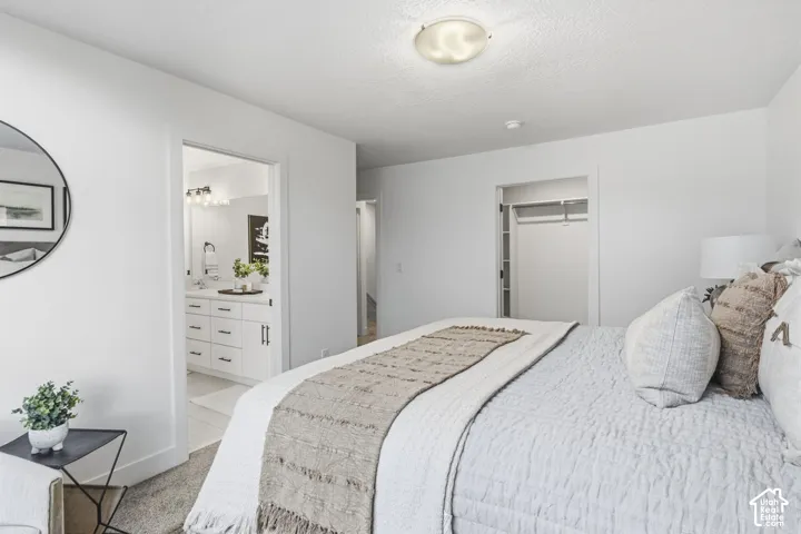 Bedroom featuring carpeted flooring and a built-in closet