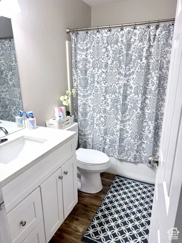 White vanity with cabinet storage, integrated sink, and chrome faucet